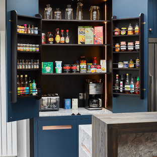 Photo of a large contemporary single-wall kitchen pantry in London with a built-in sink, flat-panel cabinets, blue cabinets, granite worktops, grey splashback, marble splashback, stainless steel appliances, ceramic flooring, an island, grey floors and grey worktops.