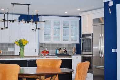 Example of a mid-sized trendy eat-in kitchen design in New York with an island, white cabinets and quartzite countertops