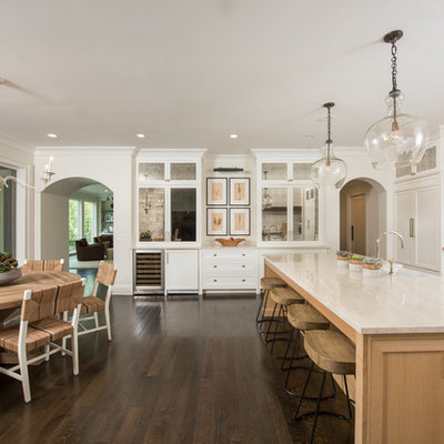 Large elegant dark wood floor and brown floor kitchen photo in Chicago with white cabinets, paneled appliances, an island and shaker cabinets