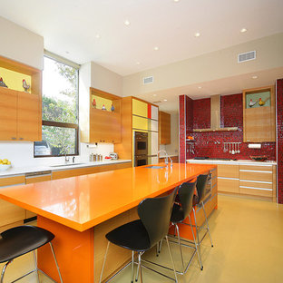 This is an example of a contemporary kitchen in Dallas with stainless steel appliances and orange benchtop.
