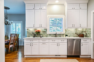 Eat-in kitchen - mid-sized transitional l-shaped light wood floor eat-in kitchen idea in Nashville with an undermount sink, shaker cabinets, green backsplash, ceramic backsplash, stainless steel appliances, no island and gray countertops