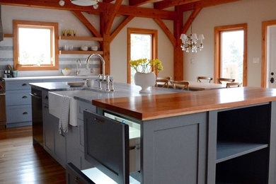 Inspiration for a mid-sized craftsman l-shaped light wood floor open concept kitchen remodel in Other with a farmhouse sink, shaker cabinets, blue cabinets, quartzite countertops, white backsplash, mosaic tile backsplash, stainless steel appliances and an island