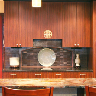 Design ideas for a large asian l-shaped eat-in kitchen in Portland with flat-panel cabinets, dark wood cabinets, granite benchtops, metallic splashback, stainless steel appliances, light hardwood floors, with island, an undermount sink and porcelain splashback.