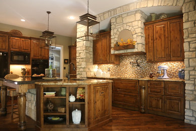 Example of a large mountain style single-wall dark wood floor and brown floor eat-in kitchen design in St Louis with a drop-in sink, raised-panel cabinets, dark wood cabinets, granite countertops, multicolored backsplash, ceramic backsplash, black appliances and an island