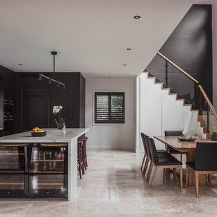 Design ideas for a mid-sized contemporary galley eat-in kitchen in Central Coast with black cabinets, quartz benchtops, travertine floors, with island, white benchtop, flat-panel cabinets, window splashback, stainless steel appliances and beige floor.