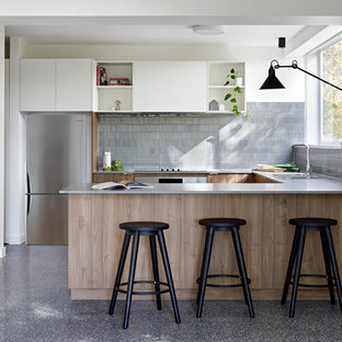 Small contemporary u-shaped kitchen in Melbourne with a double-bowl sink, medium wood cabinets, quartz benchtops, grey splashback, ceramic splashback, stainless steel appliances, concrete floors, grey floor, grey benchtop, flat-panel cabinets and a peninsula.