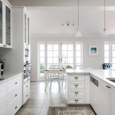 Transitional u-shaped beige floor eat-in kitchen photo in Perth with a double-bowl sink, shaker cabinets, white cabinets, gray backsplash, paneled appliances and white countertops