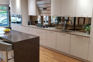 Photo of a contemporary kitchen in Surrey with quartz worktops, metallic splashback and metal splashback.