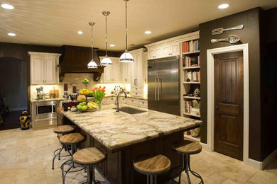 Large transitional l-shaped travertine floor and beige floor kitchen photo in Other with an undermount sink, raised-panel cabinets, white cabinets, quartzite countertops, beige backsplash, stone tile backsplash, stainless steel appliances and multicolored countertops