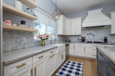 Large eclectic l-shaped light wood floor and multicolored floor eat-in kitchen photo in Phoenix with a farmhouse sink, shaker cabinets, yellow cabinets, quartzite countertops, gray backsplash, marble backsplash, stainless steel appliances and an island