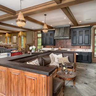 Photo of a large eclectic galley open plan kitchen in New York with a farmhouse sink, raised-panel cabinets, brown cabinets, marble benchtops, brown splashback, panelled appliances, porcelain floors and a peninsula.