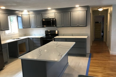 Medium sized traditional l-shaped kitchen/diner in Boston with a submerged sink, raised-panel cabinets, grey cabinets, onyx worktops, black appliances, ceramic flooring, an island and white floors.