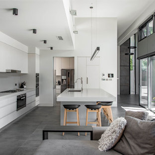 Design ideas for a contemporary l-shaped open plan kitchen in Canberra - Queanbeyan with an undermount sink, flat-panel cabinets, grey cabinets, grey splashback, with island, grey floor and grey benchtop.