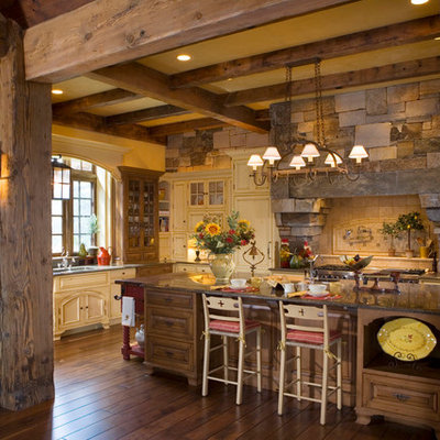 Kitchen - rustic kitchen idea in Other with raised-panel cabinets, medium tone wood cabinets, beige backsplash and stainless steel appliances