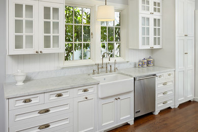 Inspiration for a large transitional single-wall dark wood floor and brown floor enclosed kitchen remodel in San Francisco with shaker cabinets, white cabinets, marble countertops, white backsplash, stainless steel appliances, an island and a farmhouse sink