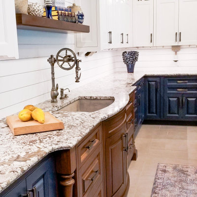 Example of a transitional beige floor kitchen design in Portland Maine with an undermount sink, raised-panel cabinets, blue cabinets and gray countertops