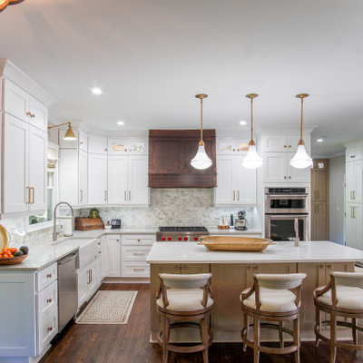 Open concept kitchen - transitional u-shaped medium tone wood floor and brown floor open concept kitchen idea in Atlanta with a farmhouse sink, shaker cabinets, white cabinets, multicolored backsplash, subway tile backsplash, stainless steel appliances, an island and white countertops