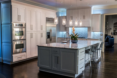 Eat-in kitchen - mid-sized contemporary l-shaped dark wood floor and brown floor eat-in kitchen idea in Atlanta with a farmhouse sink, shaker cabinets, white cabinets, marble countertops, blue backsplash, ceramic backsplash, stainless steel appliances and an island