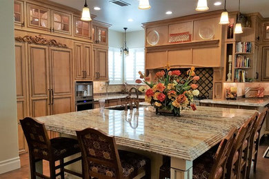Inspiration for a huge timeless u-shaped medium tone wood floor and brown floor kitchen pantry remodel in Other with an undermount sink, raised-panel cabinets, medium tone wood cabinets, granite countertops, multicolored backsplash, mosaic tile backsplash, stainless steel appliances and an island