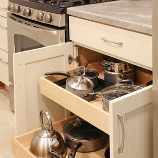 Small transitional galley separate kitchen in Minneapolis with an integrated sink, shaker cabinets, white cabinets, beige splashback, glass tile splashback, stainless steel appliances and vinyl floors.