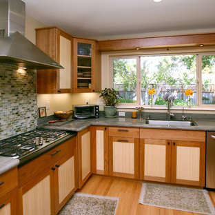 Design ideas for an eclectic kitchen in San Francisco with recessed-panel cabinets, medium wood cabinets, blue splashback, glass tile splashback and light hardwood floors.