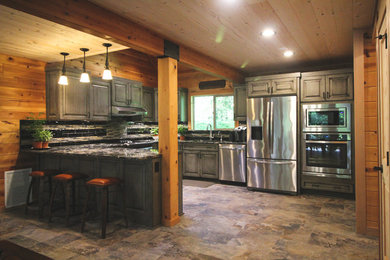 Large mountain style u-shaped ceramic tile and multicolored floor eat-in kitchen photo in Portland with a double-bowl sink, raised-panel cabinets, gray cabinets, granite countertops, multicolored backsplash, matchstick tile backsplash, stainless steel appliances and no island