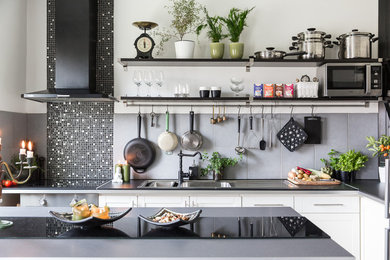 Mittelgroße Nordische Küche ohne Insel in L-Form mit Schrankfronten mit vertiefter Füllung, weißen Schränken, Küchenrückwand in Grau und Rückwand aus Keramikfliesen in Stockholm