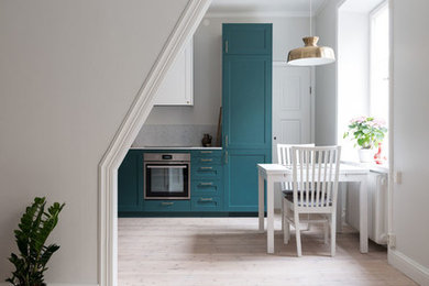 Photo of a small classic l-shaped open plan kitchen in Stockholm with beaded cabinets, turquoise cabinets, engineered stone countertops, beige splashback, no island and beige worktops.