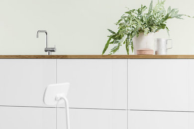 HLA Design in white with white metal applications and a solid oak worktop