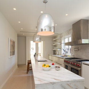 Contemporary enclosed kitchen designs - Inspiration for a contemporary galley beige floor enclosed kitchen remodel in Miami with an undermount sink, flat-panel cabinets, white cabinets, beige backsplash, stainless steel appliances, an island and white countertops