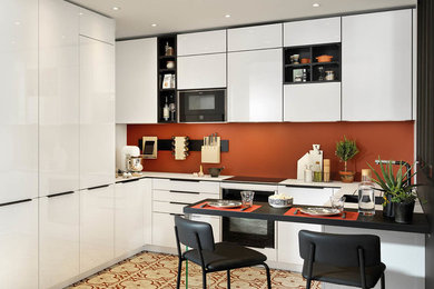 Photo of a contemporary u-shaped kitchen in Other with flat-panel cabinets, orange splashback, a breakfast bar, multi-coloured floors and white worktops.