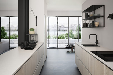 Inspiration for a scandi single-wall open plan kitchen in Copenhagen with a submerged sink, flat-panel cabinets, integrated appliances, painted wood flooring, a breakfast bar and black floors.