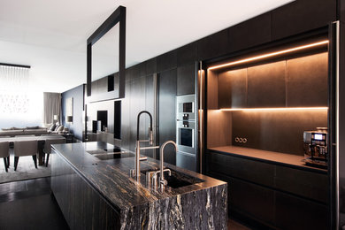 Design ideas for a large contemporary single-wall open plan kitchen in Hamburg with a double-bowl sink, stainless steel appliances and black worktops.