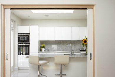 Photo of a contemporary grey and cream kitchen in London.