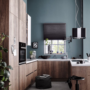 Idee per una piccola cucina industriale con lavello da incasso, ante lisce, ante marroni, top in legno, paraspruzzi blu, paraspruzzi in mattoni, parquet scuro, penisola, pavimento marrone e elettrodomestici neri