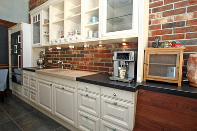 Photo of a medium sized rural single-wall kitchen/diner in Nuremberg with a built-in sink, beaded cabinets, white cabinets, red splashback, stainless steel appliances, slate flooring and no island.
