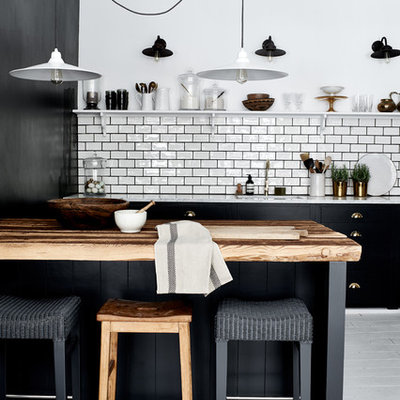 Large trendy galley painted wood floor open concept kitchen photo in Dusseldorf with white backsplash, subway tile backsplash, an island and a single-bowl sink