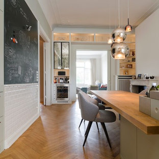 Photo of a large scandinavian kitchen in Hamburg with green cabinets, limestone benchtops, medium hardwood floors and with island.