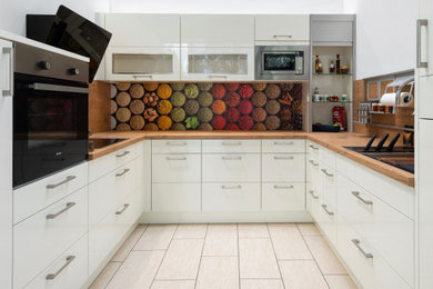 Идея дизайна: п-образная кухня в современном стиле с плоскими фасадами