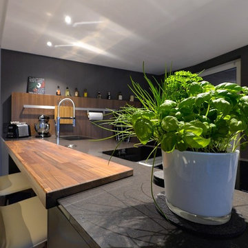Offene Wohnküche in schwarz mit Holzelementen