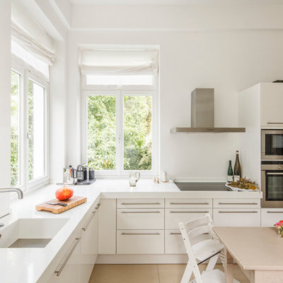 Large trendy l-shaped eat-in kitchen photo in Cologne with flat-panel cabinets, white cabinets and an integrated sink