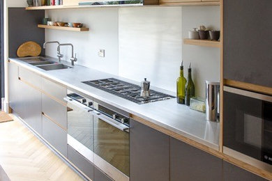 Inspiration for a contemporary kitchen in Other with a double-bowl sink, stainless steel worktops and an island.