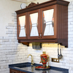 Inspiration for a small traditional single-wall separate kitchen in Other with an integrated sink, raised-panel cabinets, dark wood cabinets, solid surface benchtops, white splashback, porcelain splashback, porcelain floors, no island, blue floor, blue benchtop and timber.