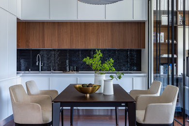 Trendy l-shaped brown floor kitchen photo in Moscow with black backsplash and flat-panel cabinets