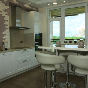 Inspiration for a large contemporary l-shaped separate kitchen in Moscow with an undermount sink, raised-panel cabinets, white cabinets, solid surface benchtops, beige splashback, slate splashback, porcelain floors, with island, green floor and beige benchtop.