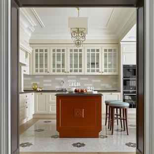 Inspiration for a large traditional l-shaped open plan kitchen in Moscow with beige cabinets, quartz benchtops, beige splashback, ceramic splashback, black appliances, porcelain floors, with island, beige floor and glass-front cabinets.
