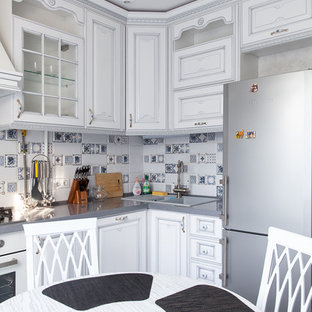 This is an example of a shabby-chic style separate kitchen in Moscow with a double-bowl sink, raised-panel cabinets, white cabinets, multi-coloured splashback, white appliances and no island.