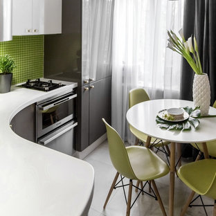 Inspiration for a small scandinavian l-shaped eat-in kitchen in Moscow with flat-panel cabinets, grey cabinets, solid surface benchtops, green splashback, mosaic tile splashback, stainless steel appliances, no island, an integrated sink and marble floors.