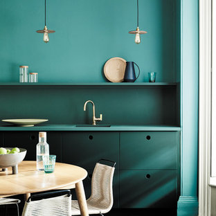 Photo of a contemporary eat-in kitchen in Moscow with flat-panel cabinets, green cabinets, green splashback, green benchtop, a single-bowl sink and dark hardwood floors.
