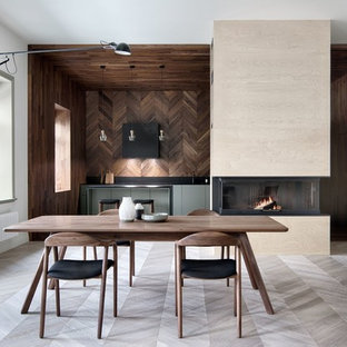 This is an example of a large scandinavian single-wall eat-in kitchen in Saint Petersburg with light hardwood floors, flat-panel cabinets, grey floor, an undermount sink, green cabinets, black splashback, panelled appliances and no island.